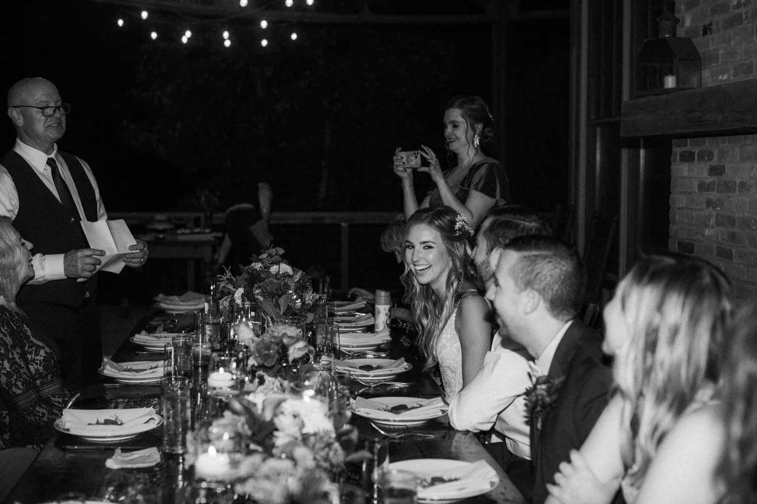 Event guests gathered around a candlelit dinner table